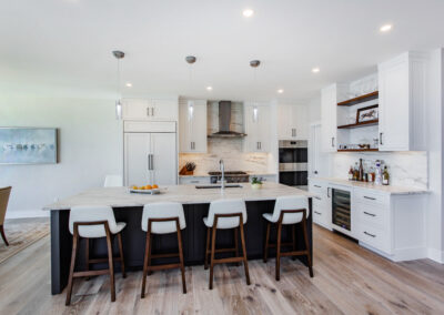 Sleek white custom kitchen cabinetry with black hardware